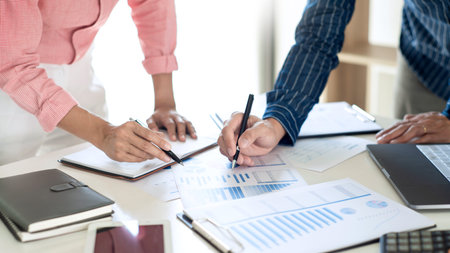 Business Team Entrepreneur discussing and analysis report chart data in office, brainstorming in...