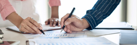 Business team working with plan on office desk with new startup project analyzing financial document...