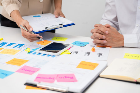business people planning startup project placing sticky notes session to share idea on glass wall,...