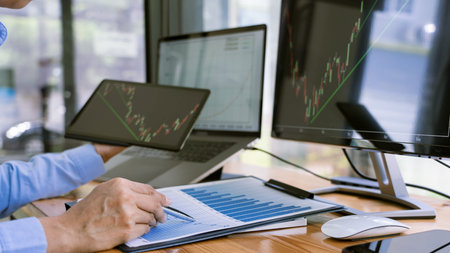 Stock Market Broker in formalwear Analyzing Graphs on  screens in the office, investment concept