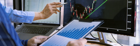 Team of stockbrokers are having a conversation on a stock exchange for investment purposes in...