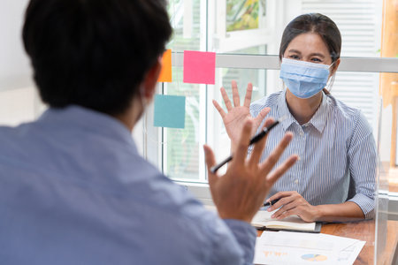 business team brainstorm they are working hard by looking through the plastic protective wall,...