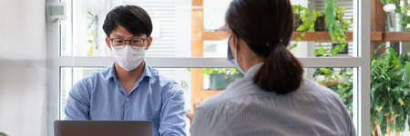 Group of Teamwork Asian business People Wearing Protective face Mask In Office During Pandemic coronavirus COVID-19, New Normal and Social distancing concept.の写真素材