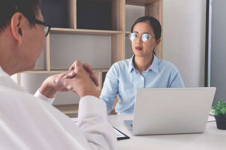 Senior and young businessman colleagues discuss online project to learning new skills or Coaching Business Team with young intern looking at pc screen in the officeの写真素材