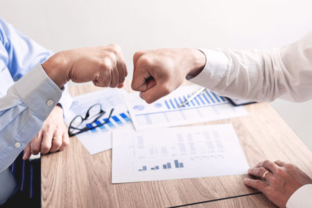 Colleagues Achievement Business Casual Fist bump together after dealing mission business, Business...