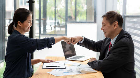 Colleagues Achievement Business Casual Fist bump together after dealing mission business, Business success and teamwork concept.の写真素材