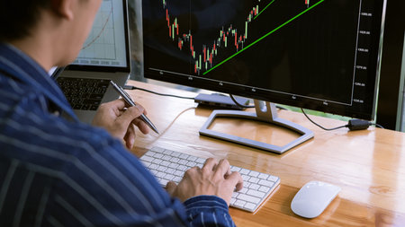 broker showing some ascending to his colleague planning and analyzing graph stock market trading...