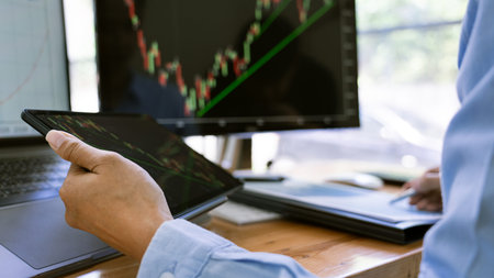 Stock Market Broker in formalwear Analyzing Graphs on  screens in the office, investment concept
