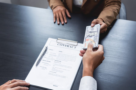 Businessmen give money to bribe partner secretly passing money, bribery and corruption concepts