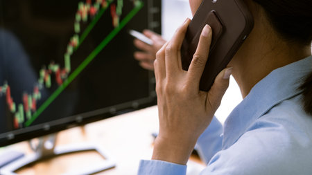 stock exchange trader working  with graphs,diagrams on monitor in modern trading office.