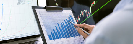 stock exchange trader working  with graphs,diagrams on monitor in modern trading office.