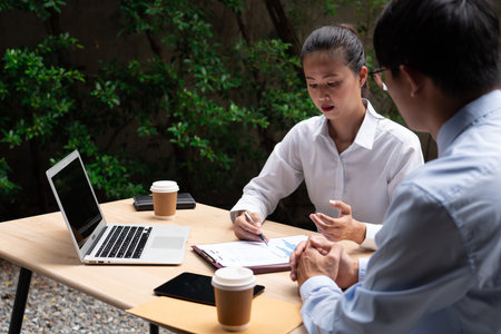 Two Business Colleagues Having Discussion new project business meeting outside office in an urban setting.の写真素材