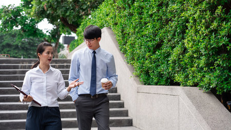 Two Business Colleagues Having Discussion new project business meeting outside office in an urban setting.の写真素材