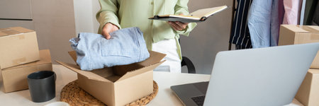 Asian business owner working at home with packing box of her online store prepare to deliver...