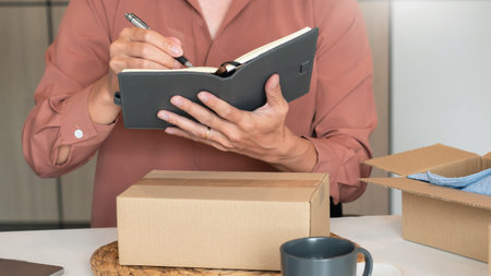 Online small business entrepreneur merchants working at store preparing products to deliver to...