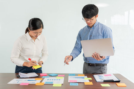 Creative group of business people brainstorming use sticky notes picking to share idea on table...