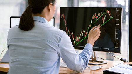 stock exchange trader working  with graphs,diagrams on monitor in modern trading office.