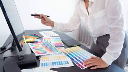 creative graphic designer choosing color scale for editing artwork while working in office