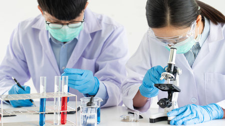 Team of Medical Research Scientists or researcher in lab coat testing their experimental in Modern...