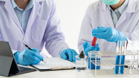 Team of Medical Research Scientists or researcher in lab coat testing their experimental in Modern...