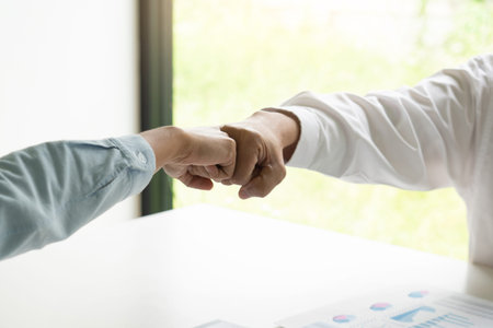 Colleagues Achievement Business Casual Fist bump together after dealing mission business, Business...