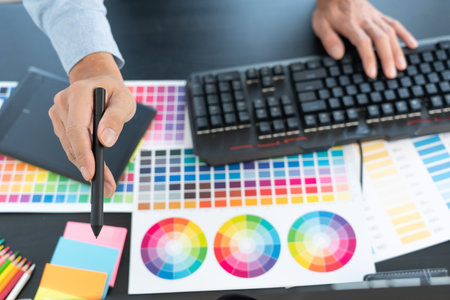 creative graphic designer choosing color scale for editing artwork while working in officeの写真素材