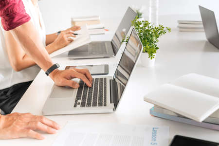 Young woman and man studying for a test or exam Tutor books with friends catching up and learning, education and school conceptの写真素材