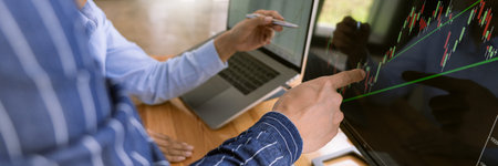 Team of stockbrokers are having a conversation on a stock exchange for investment purposes in traders office, business financial investment and technology conceptの写真素材