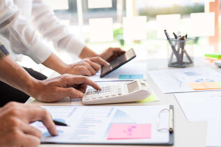 business man financial inspector and secretary making report and brainstorming with colleague in a modern co-working space.の写真素材