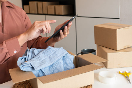 Online small business entrepreneur merchants working at store preparing products to deliver to...