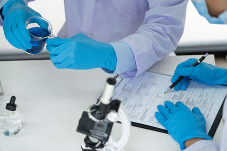 Team of Medical Research Scientists or researcher in lab coat testing their experimental in Modern laboratoryの写真素材