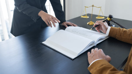 law,libra scale and hammer on the table, 2 lawyers are discussing about contract paper, law matters...