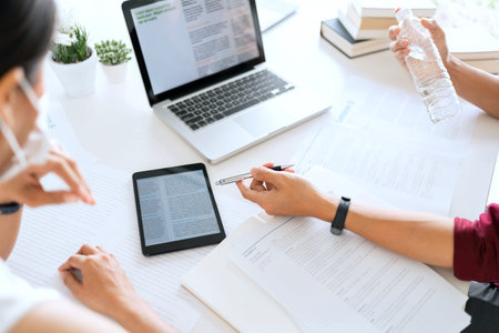 two smart colleague coworking collecting and analyzing demanding data.