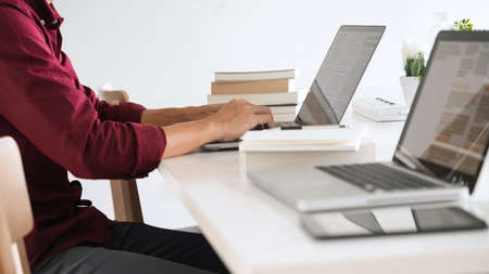 A wise officer going on internet for preparing the agenda in upcoming meeting.の写真素材