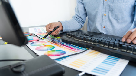 creative graphic designer choosing color scale for editing artwork while working in office
