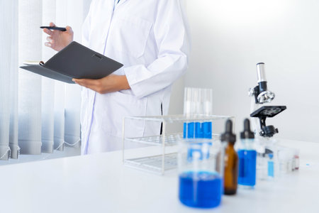 Scientist wear lab coat and protective wear are working with research or doing investigations with...