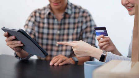 Shopping online concept a lovely couple adding credit card information to use in online financial transaction.の写真素材