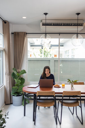 Work from home concept a female freelancer looking happy while working online in her own space...