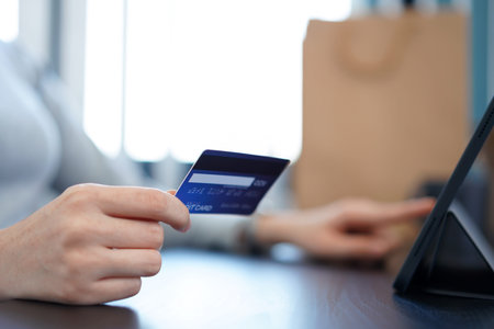 Shopping online concept a young woman using her credit card to facilitate   an online purchasing in online shopping application.の写真素材