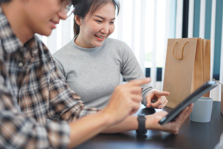 Shopping online concept a lovely couple adding credit card information to use in online financial transaction.の写真素材