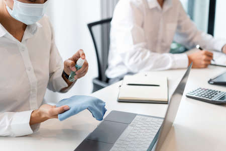 Sanitizing and cleaning the surfaces of devices before touching or using to avoid infectious virus.の写真素材