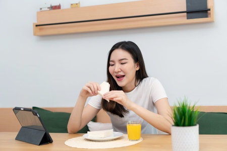 Living room concept a woman using her electronic device to work remotely in the cozy room of the coffee shop.の写真素材
