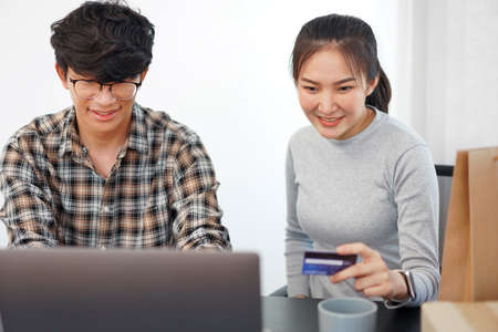 Shopping online concept a couple enjoying online shopping and buying many stuffs by a credit card.の写真素材