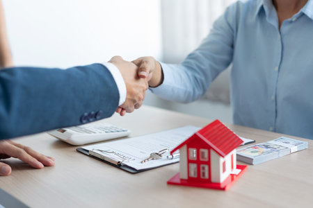 The real estate concept the house estate and his client shaking hands for accepting to make the land sale contract.の写真素材
