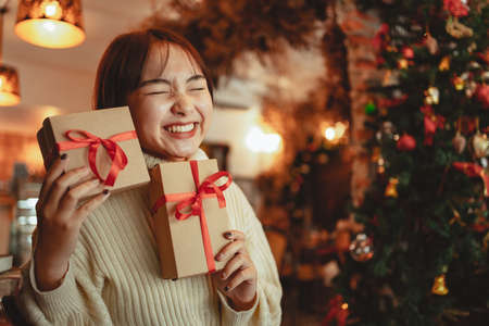 Happiness girl hold christmas gift box at home celebration concept.の写真素材