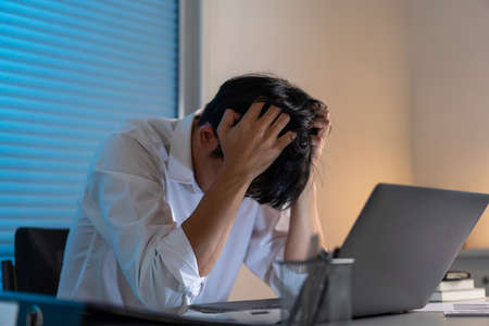 law concept the legal officer standing and concentrating on reading the legislative conditions before signing the paper.の写真素材