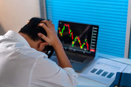 Overwork Concept The male who works in the office holding his head with stressful emotion.の写真素材