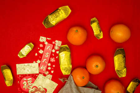Above view accessories of Chinese new year or Mood day festival oranges gold and Ang pao pockets whit cherry blossom branch decorationsの写真素材