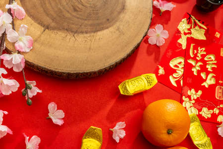Above view accessories of Chinese new year or Mood day festival oranges gold and Ang pao pockets whit cherry blossom branch decorationsの写真素材