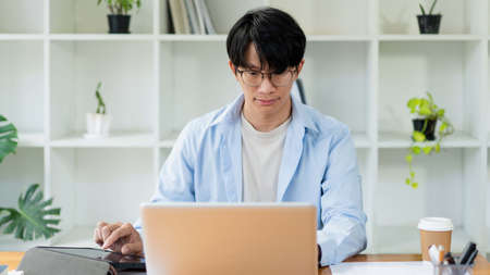 Business analyst concept the hands of businessman inserting the information of the products by using laptop.の写真素材